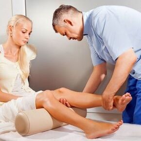 Doctor examines patient's knee joint